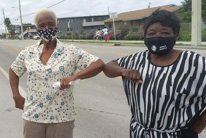 SOUTH BAY — Shirley Walker Turner (left) and Frances O’Neal (right) share an elbow bump when they ran into each other at the event Monday.
